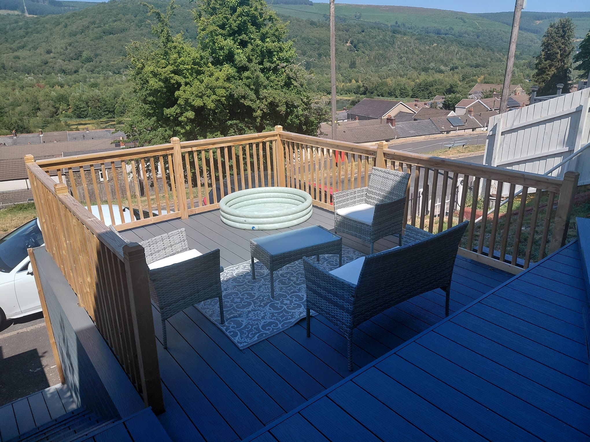Finished raised composite deck with timber balustrade and outdoor seating