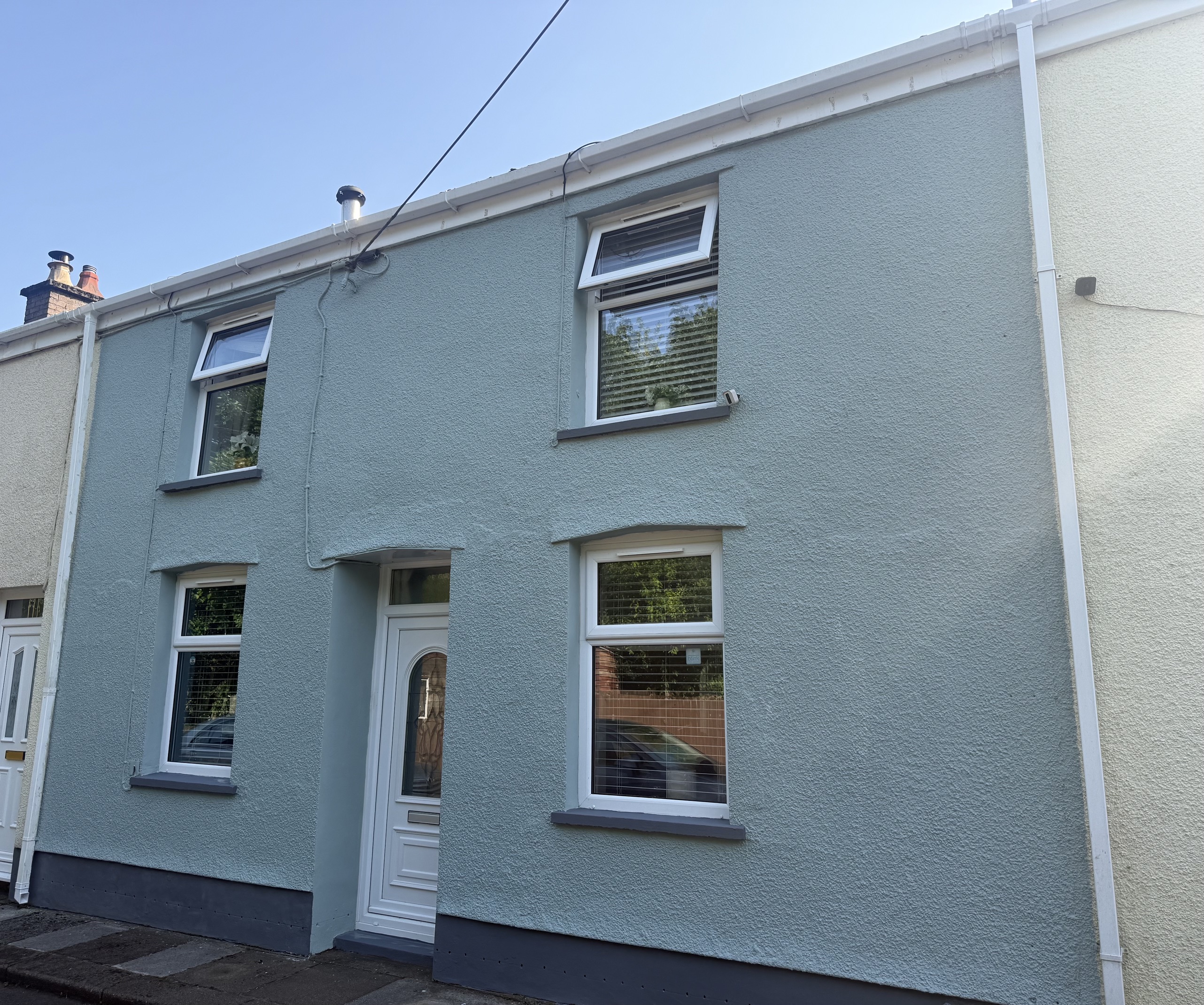 Terraced house with a freshly painted blue-green exterior