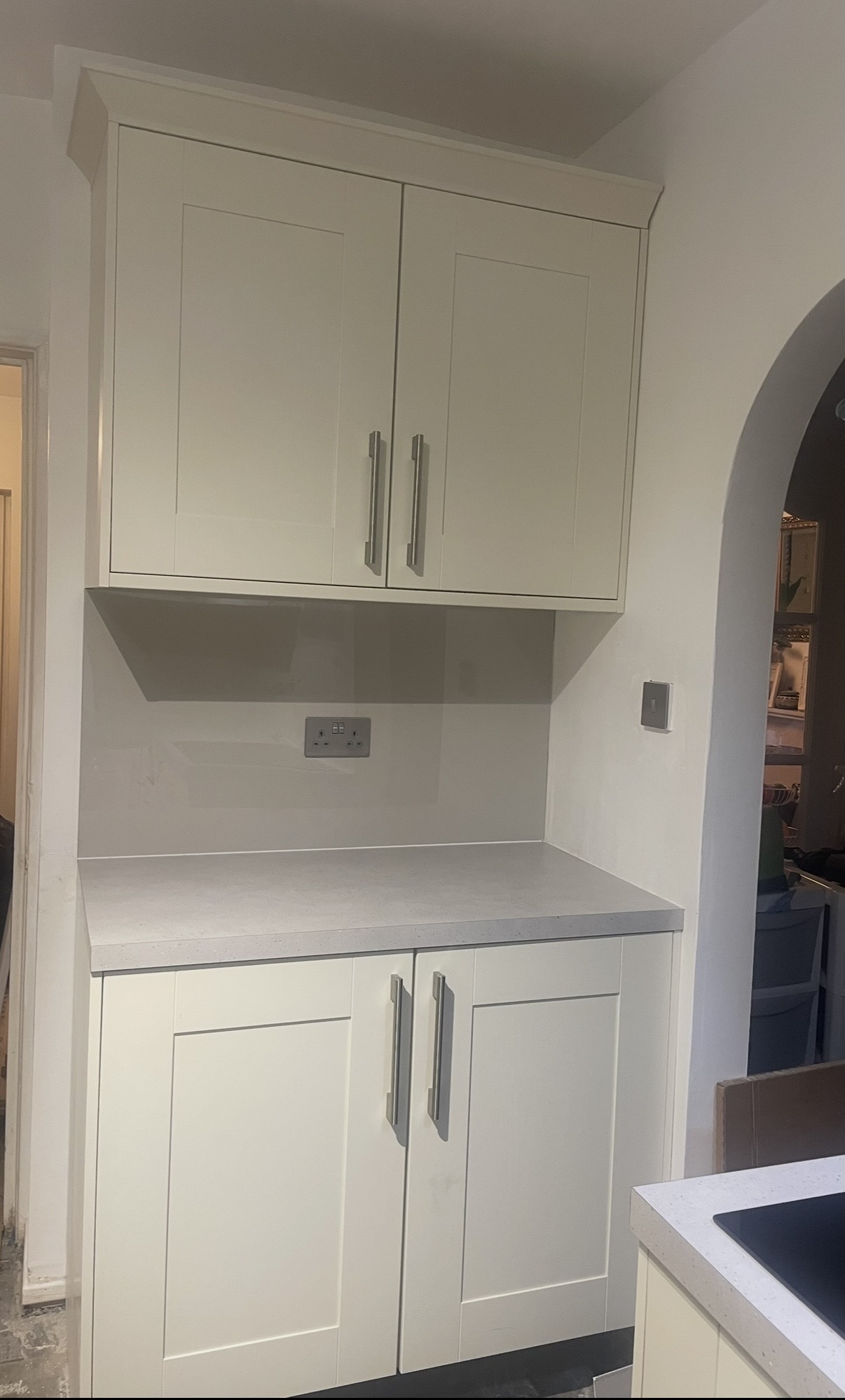 Completed fitted kitchen cupboards and countertop in the recess